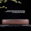 Handmade antique rectangular purple clay flower pot on tabletop