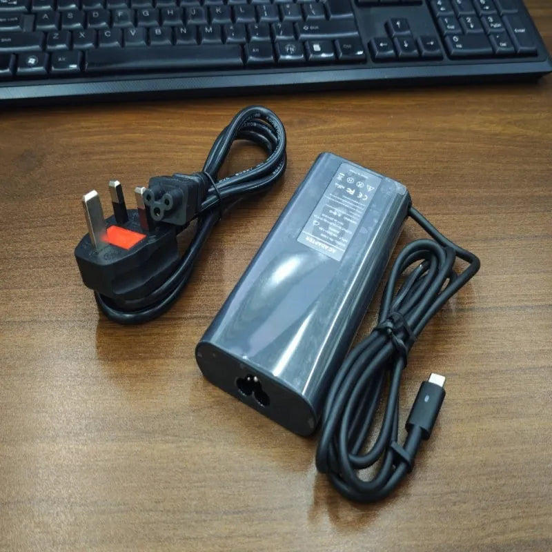Black 65W Type-C laptop power adapter with multiple international power plugs