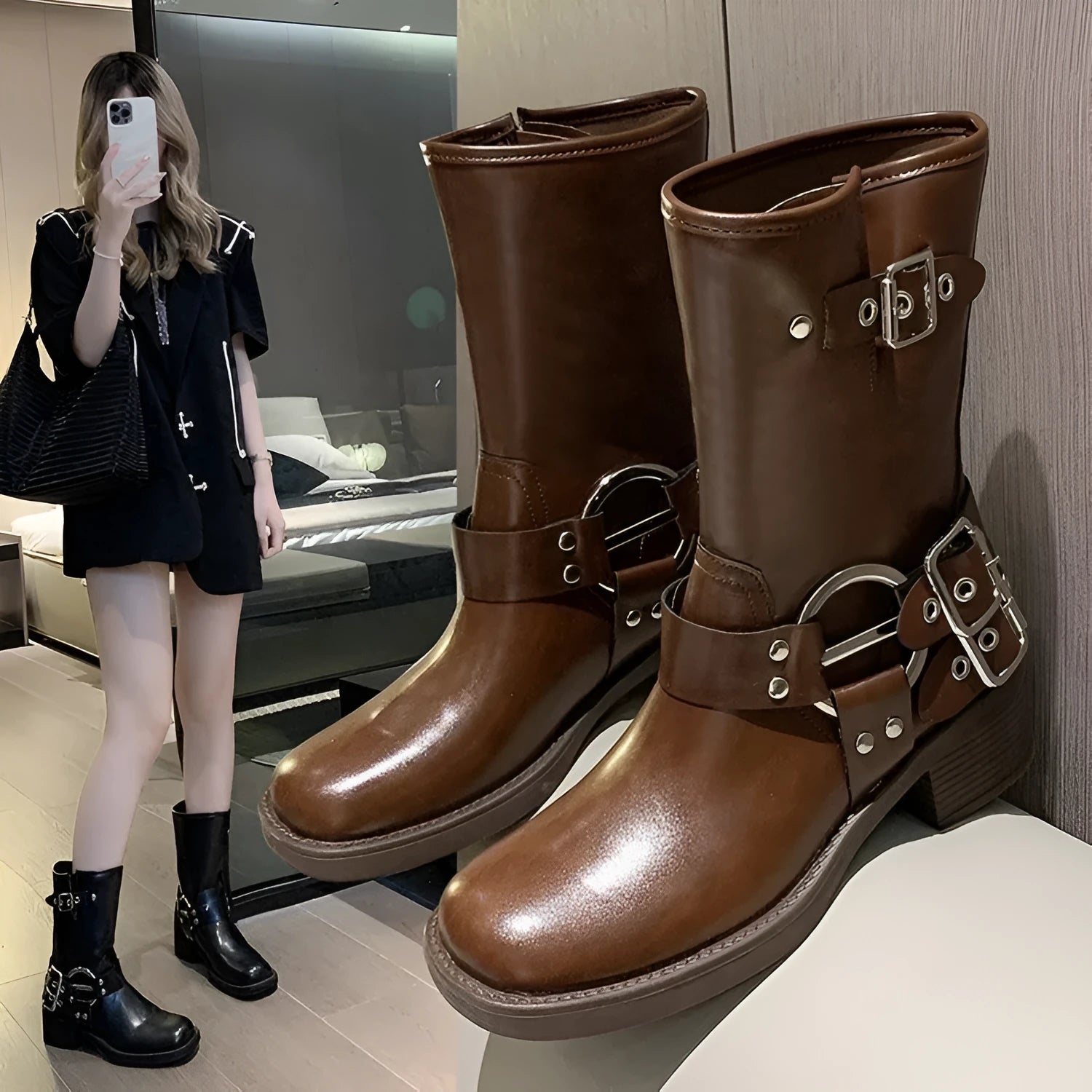 Women's black platform boots with a silver buckle detail at mid-calf height.