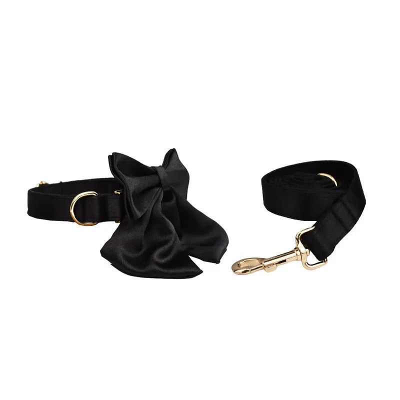 Complete dog walking set showing a cloth collar, matching leash, lightweight vest, and decorative bow for pets.