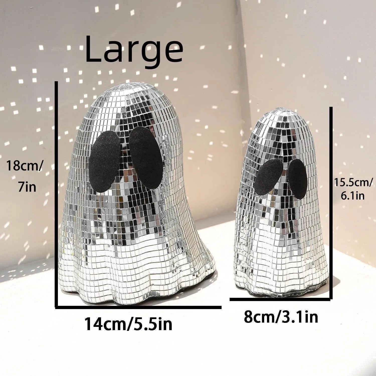 Silver Halloween ghost ornament with mosaic glass surface on wooden desk
