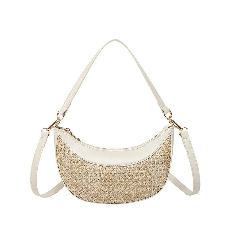 Hard woven straw dumpling-shaped crossbody bag in green with contrast stitching and a single shoulder strap.