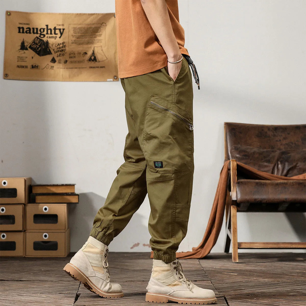 Men's khaki cotton tapered harem pants with an ankle band and loose fit.