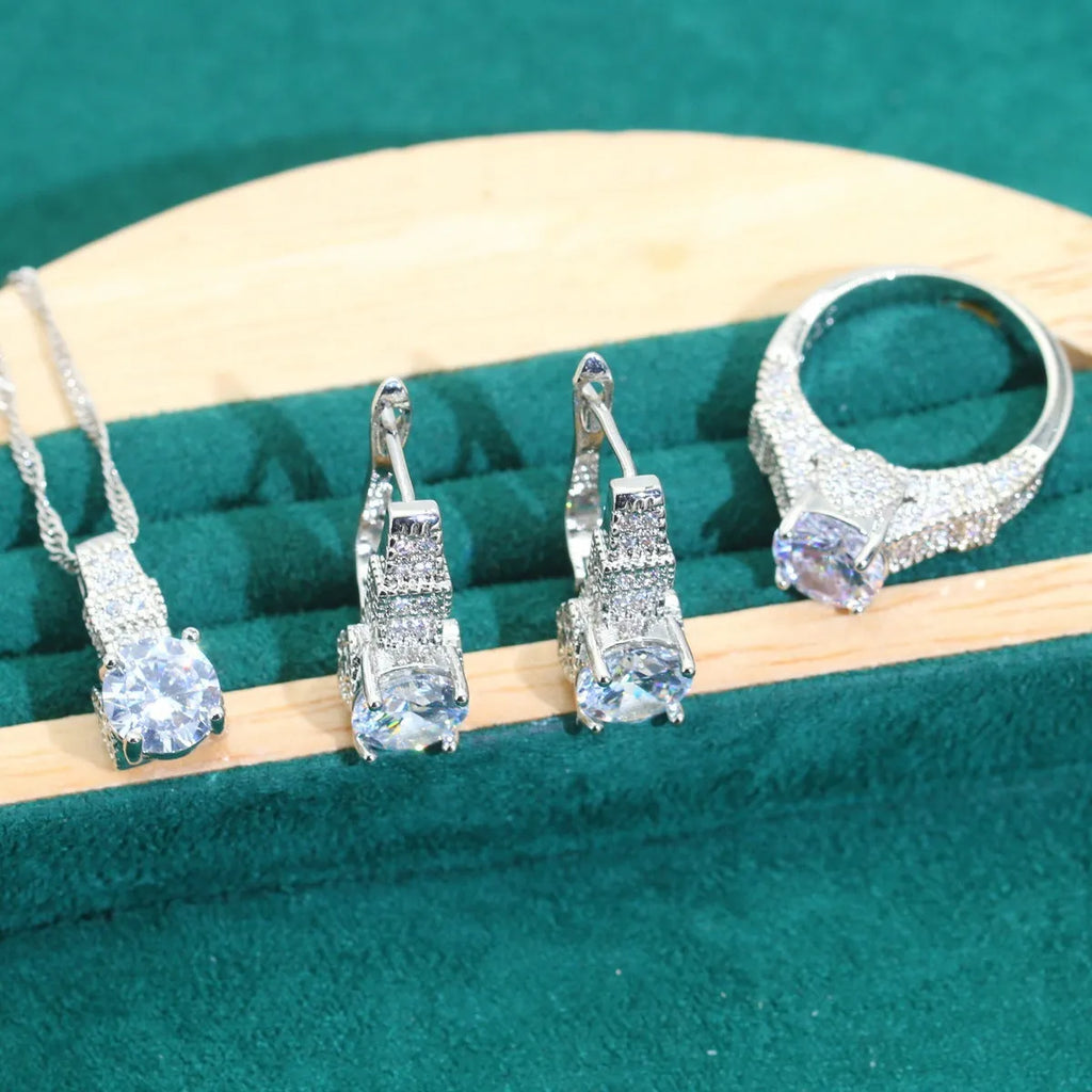 Four-piece bridal jewellery set showing necklace, earrings, ring, and bracelet with zircon alloy pendants