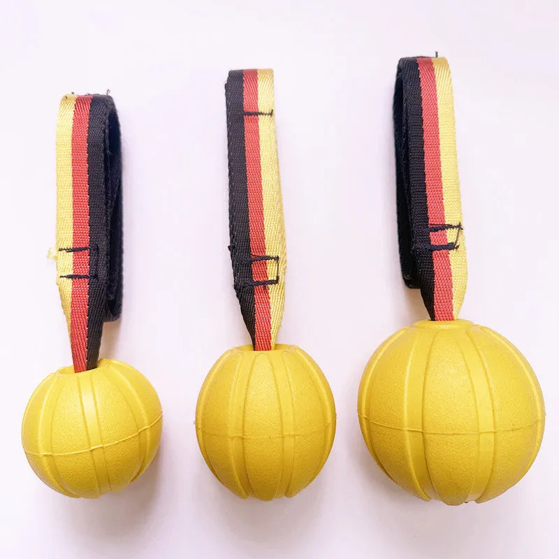 Floating camouflage and yellow EVA dog training balls with string tethers in three different sizes