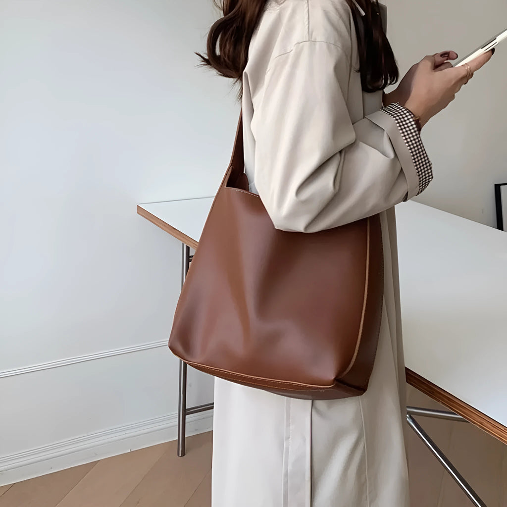 Women's soft PU leather shoulder bag with swing thread detailing in black or brown colour options