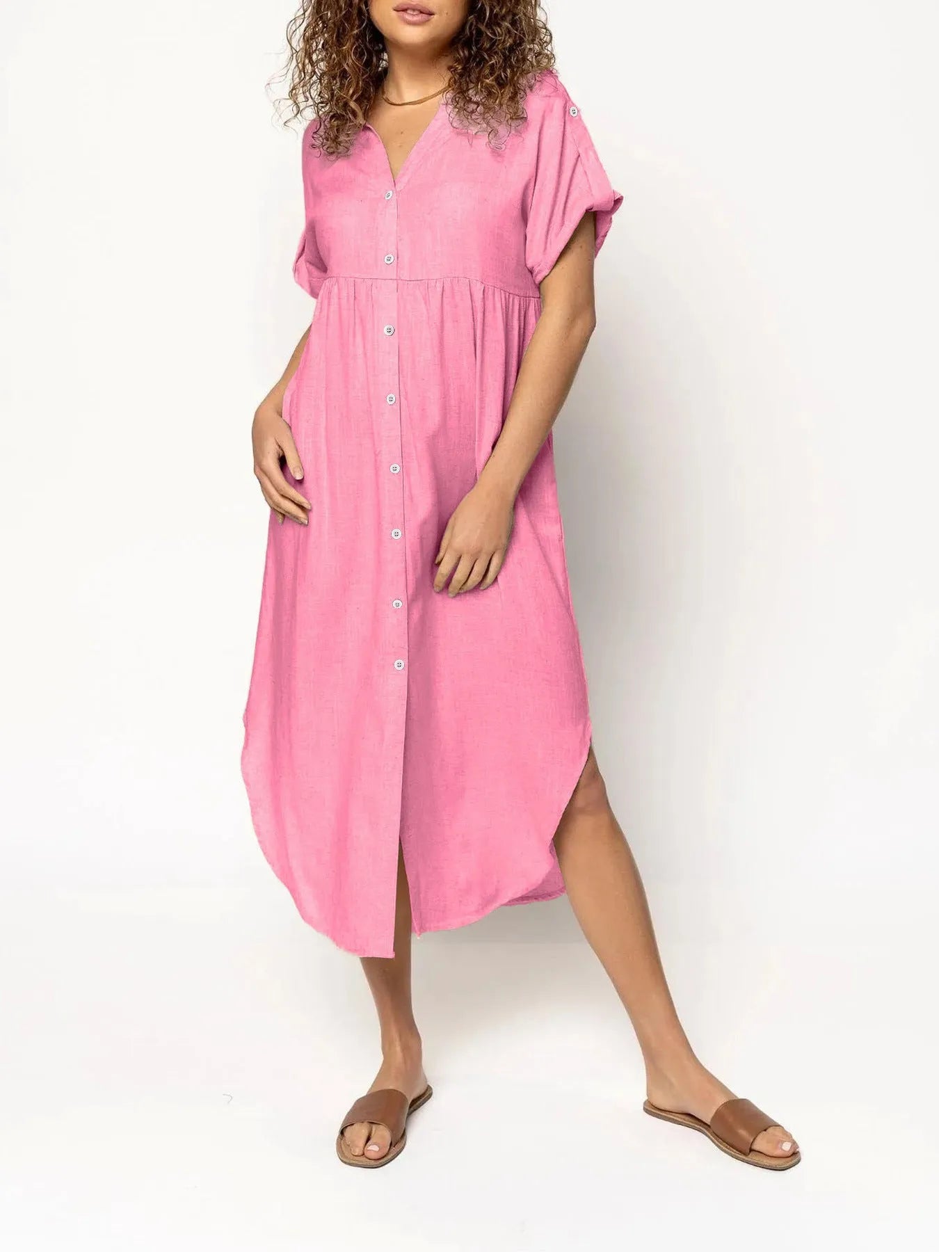 A woman wearing a casual solid-colour mid-length dress with a button-down front.