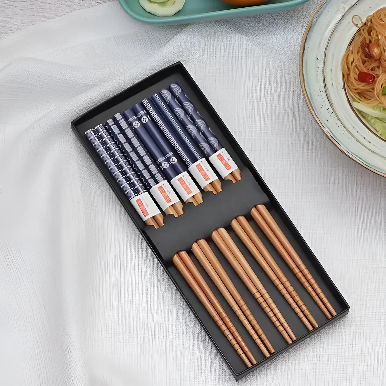 Set of five pairs of bamboo chopsticks with Japanese lucky cat and elegant blue patterns in gift box.
