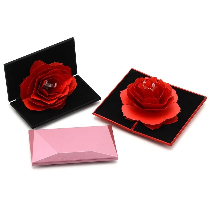 3D Love Box heart-shaped rotating rose flower ring box in red plastic on white background