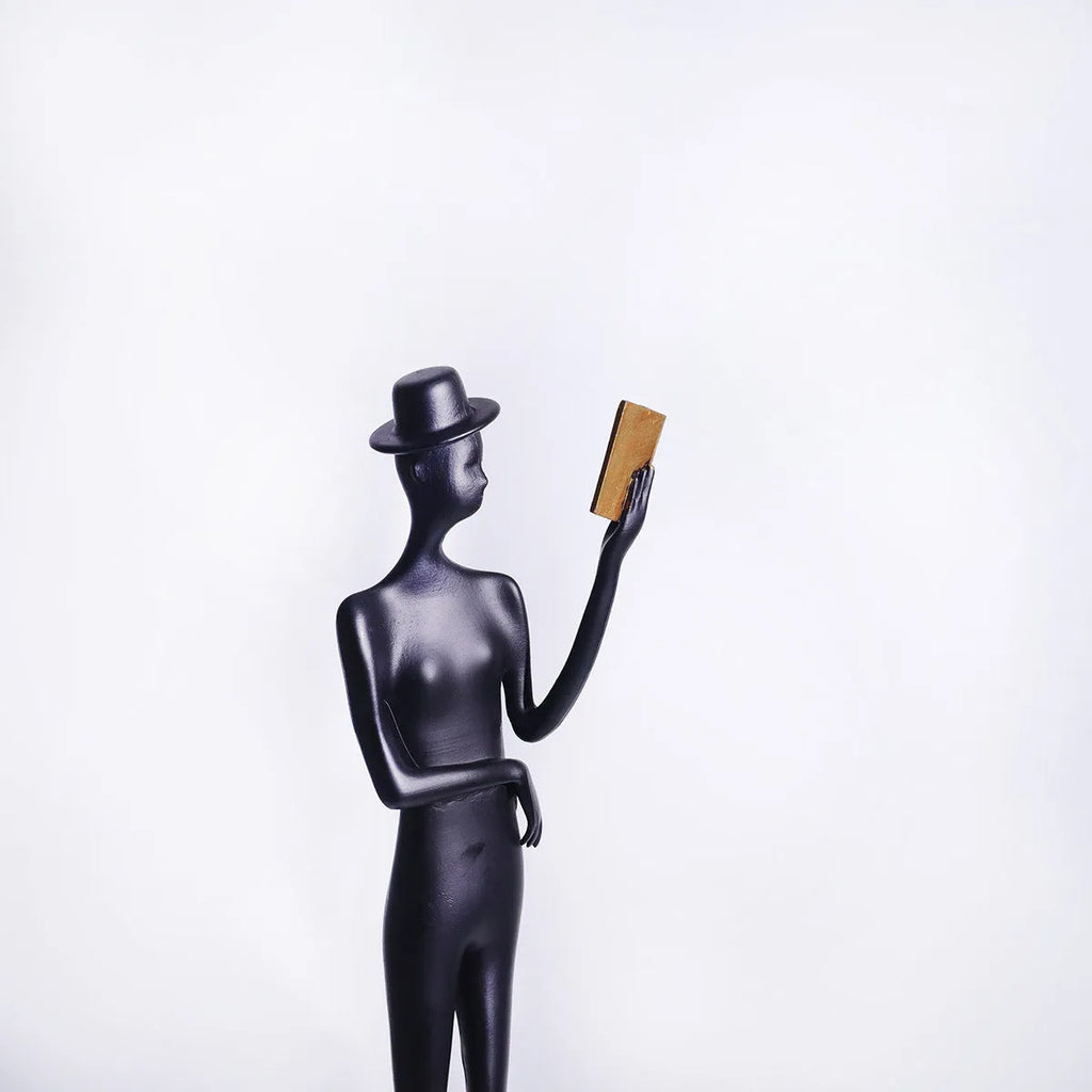 Black metal cast aluminium desktop sculpture with modern minimalist character figure design