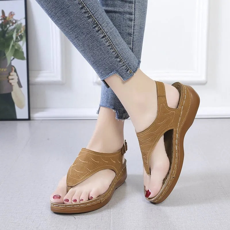 Women's casual wedge heel flip flop sandals with an adjustable buckle strap in black.