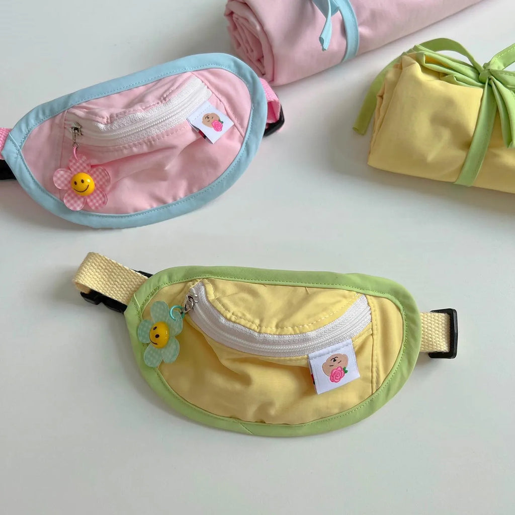 Powder blue backpack-style dog poop bag dispenser clipped to a harness.