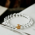 Geometric unisex bracelet with black obsidian agate beads, white crystal beads, and a golden dragon crystal focal bead.