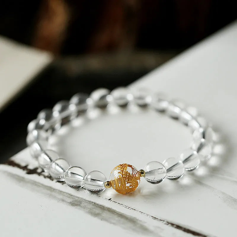 Geometric unisex bracelet with black obsidian agate beads, white crystal beads, and a golden dragon crystal focal bead.
