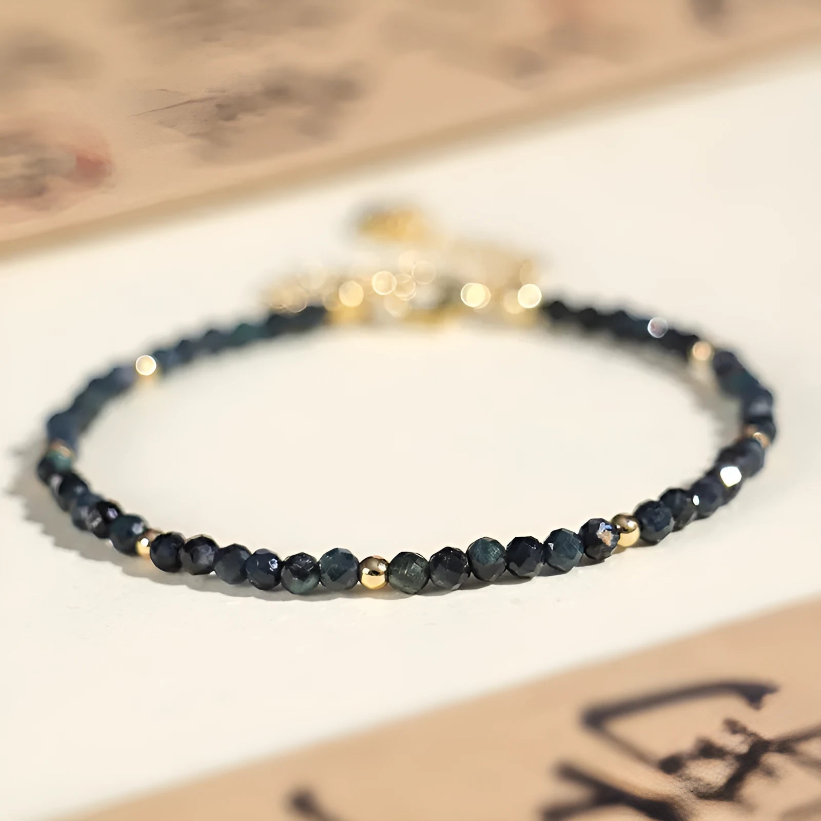 Blue tourmaline spacer bead bracelet with 3mm cut beads and blue gold accents