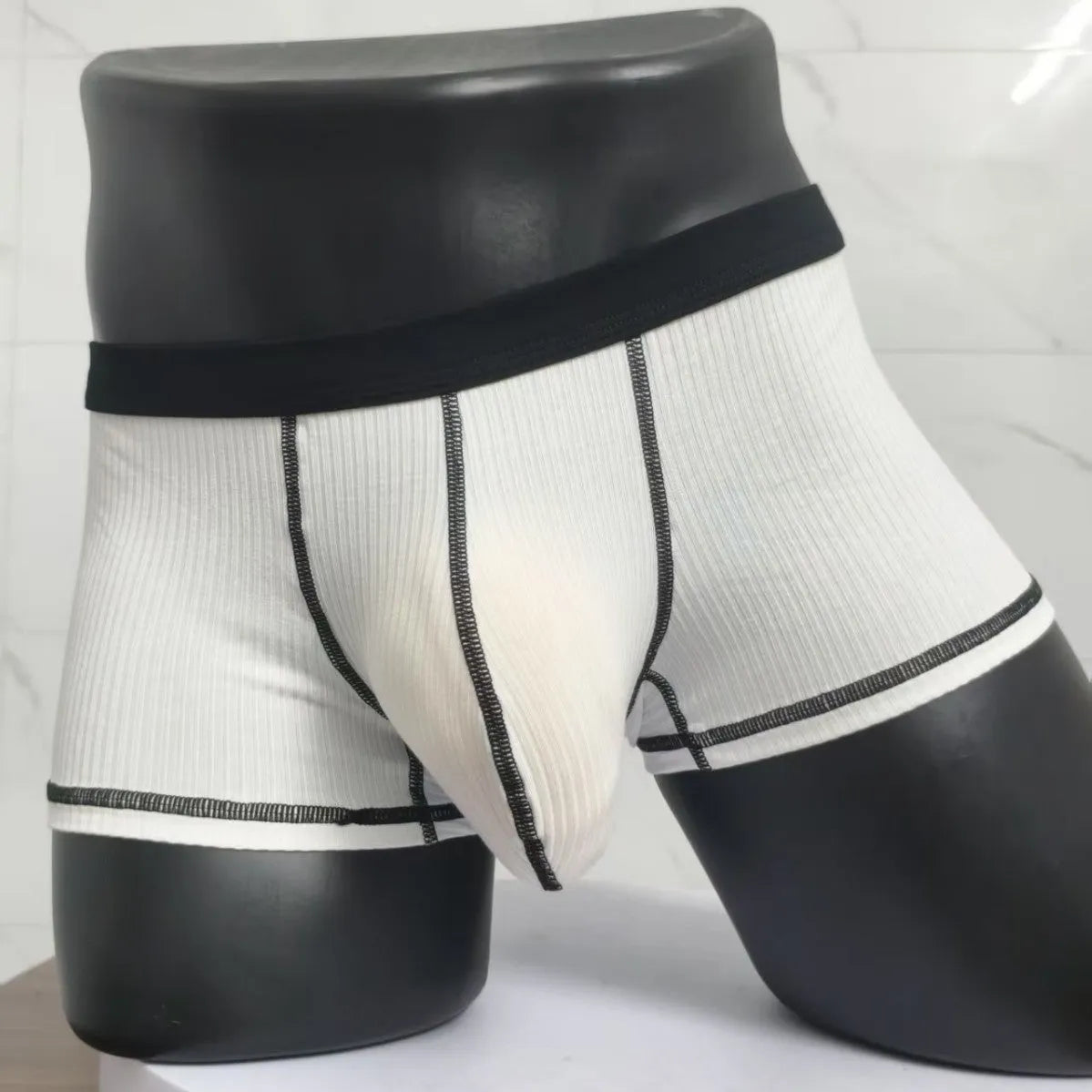 Men's solid colour boxer shorts on a white background, showing thin breathable fabric.