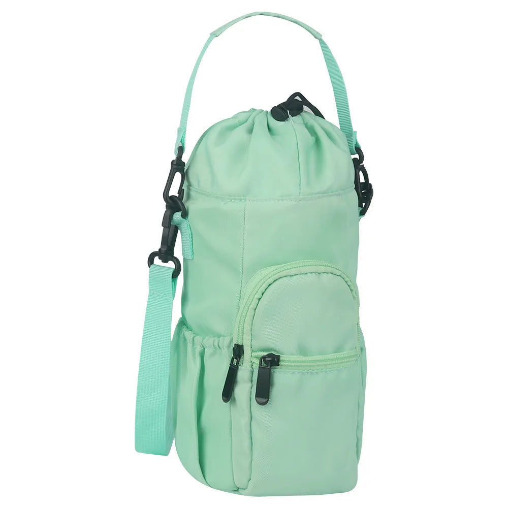 Black cloth water bottle pouch with crossbody strap and side handle on a model.