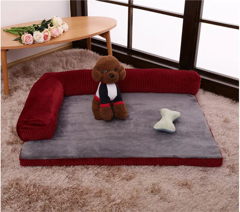 Corduroy dog sofa bed in grey, showing high sides and non-slip base, placed on a wooden floor.