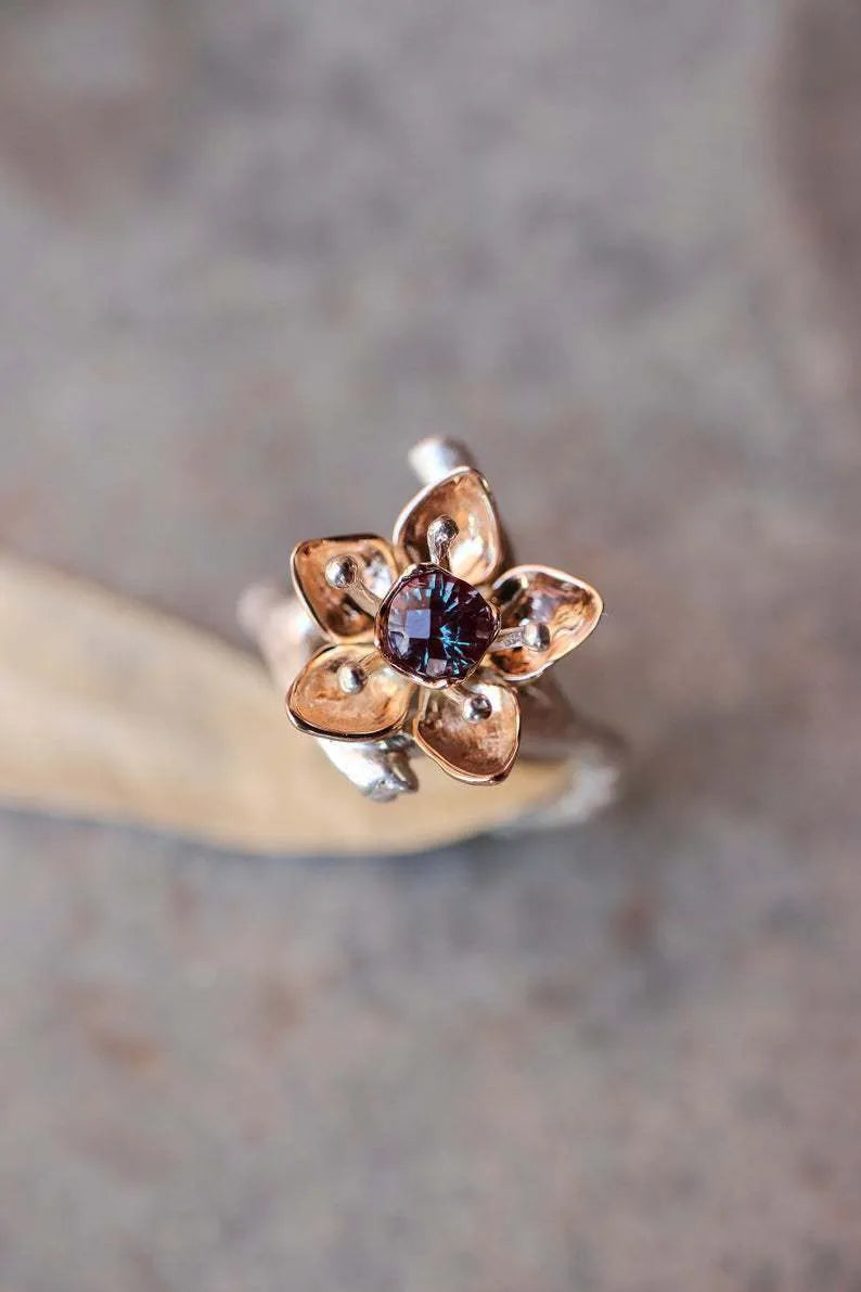Silver two-tone floral geometric women's alloy ring shown on a finger.