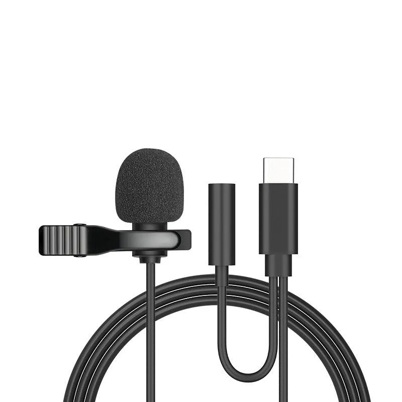 White lavalier lapel clip microphone with long cable and in-ear earpieces next to an iPhone.