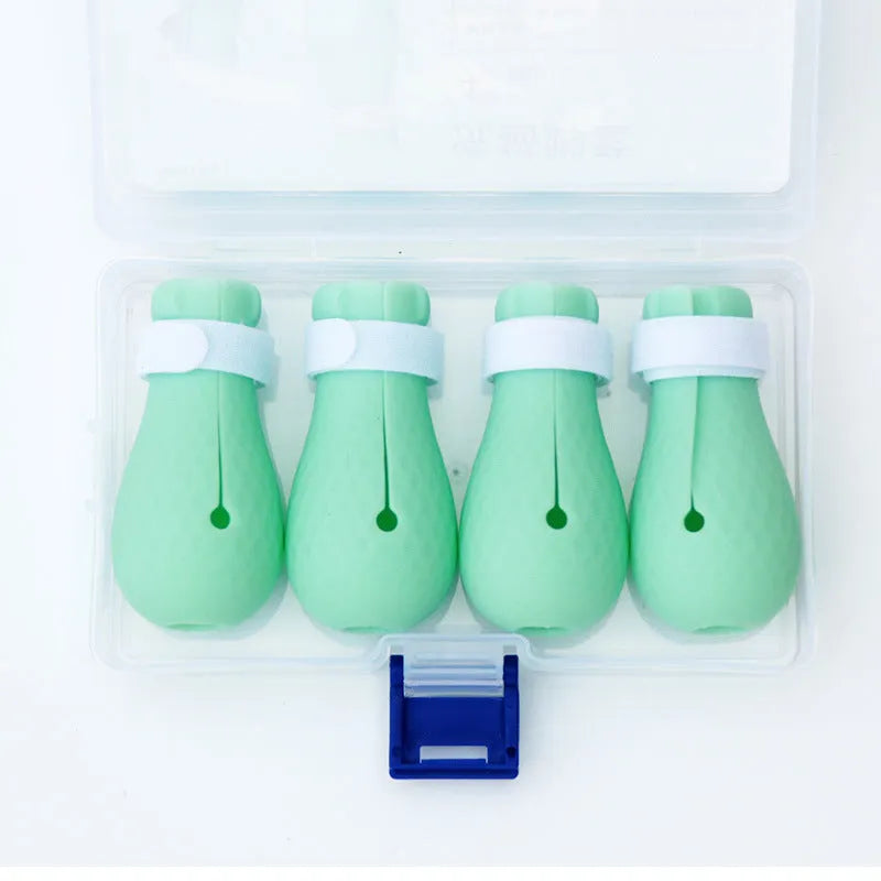 Four green silicone cat anti-scratch foot covers for paw protection during washing and medical care
