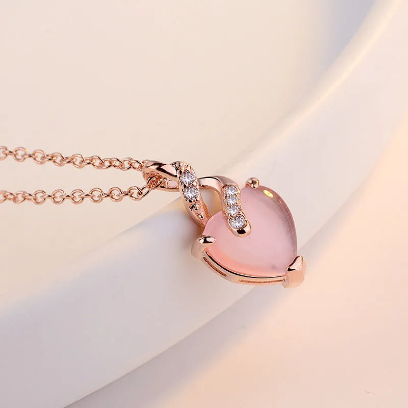 Women's heart-shaped artificial crystal pendant on rose gold electroplated cross chain necklace