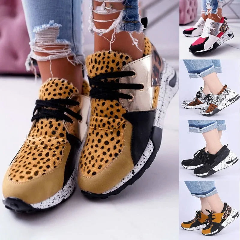 Women's black suede casual sneakers with a wedge heel and round toe on a light background.