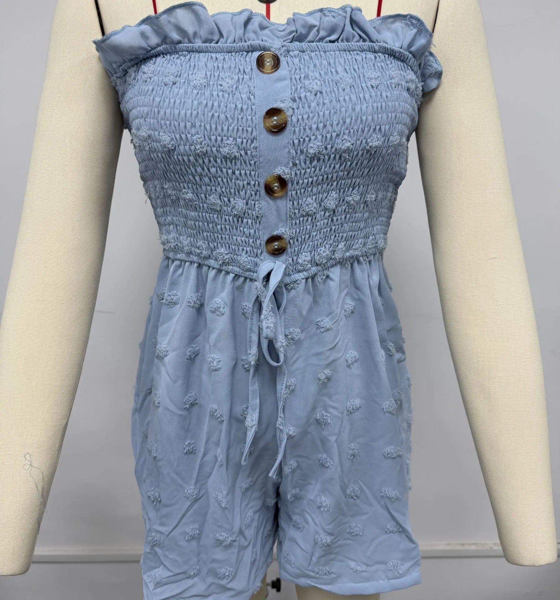 Women's sleeveless off-shoulder jumpsuit in solid colour with elastic waist and button details