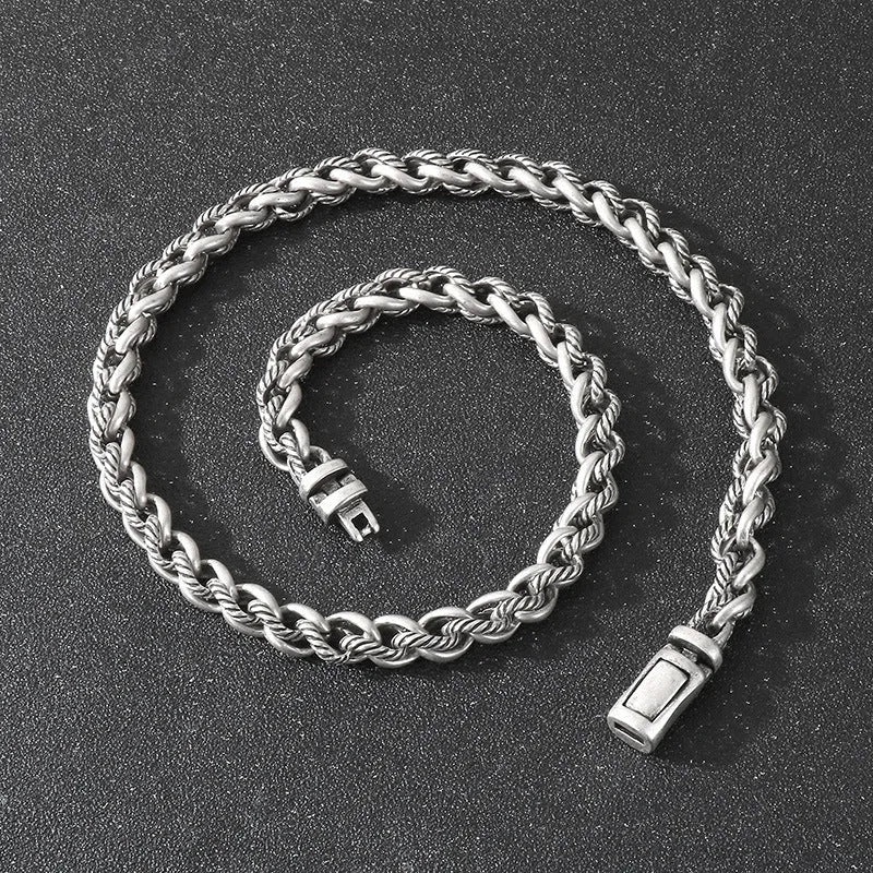 Men's antique silver titanium steel keel chain necklace with large hemp flower links on a grey background.