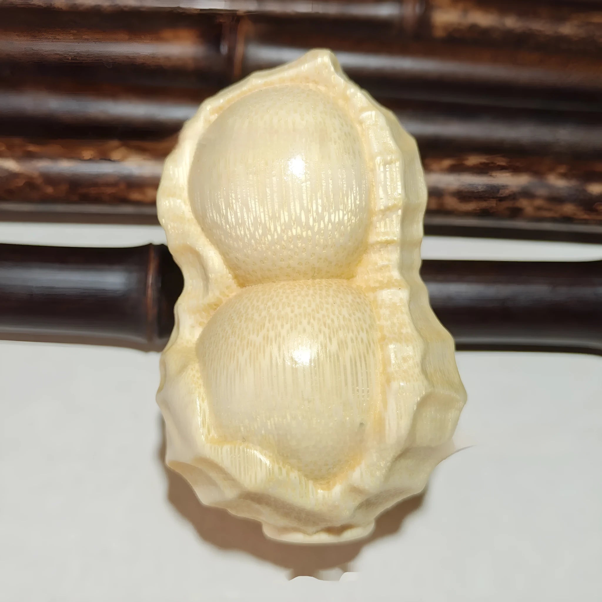Modern minimalist solid bamboo carving peanut ornament symbolising good fortune