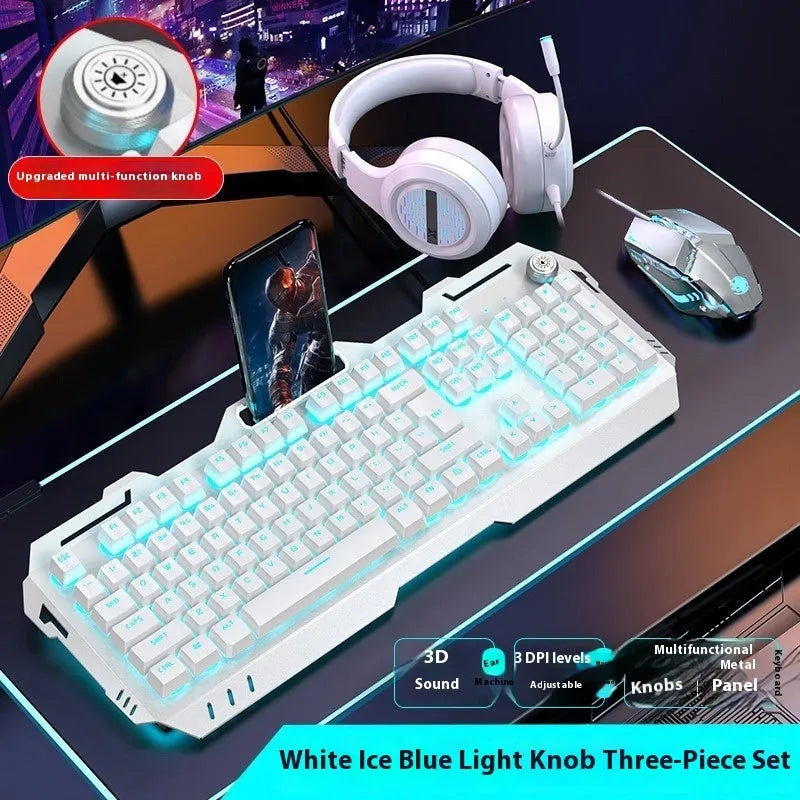 Aluminium gaming keyboard with volume knob, shown in metal grey with RGB lighting alongside optional macro mouse and headset.