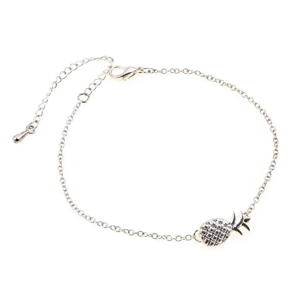 Women's alloy pineapple bracelet on wrist, showing B178 gold or silver finish and fruit-shaped design.