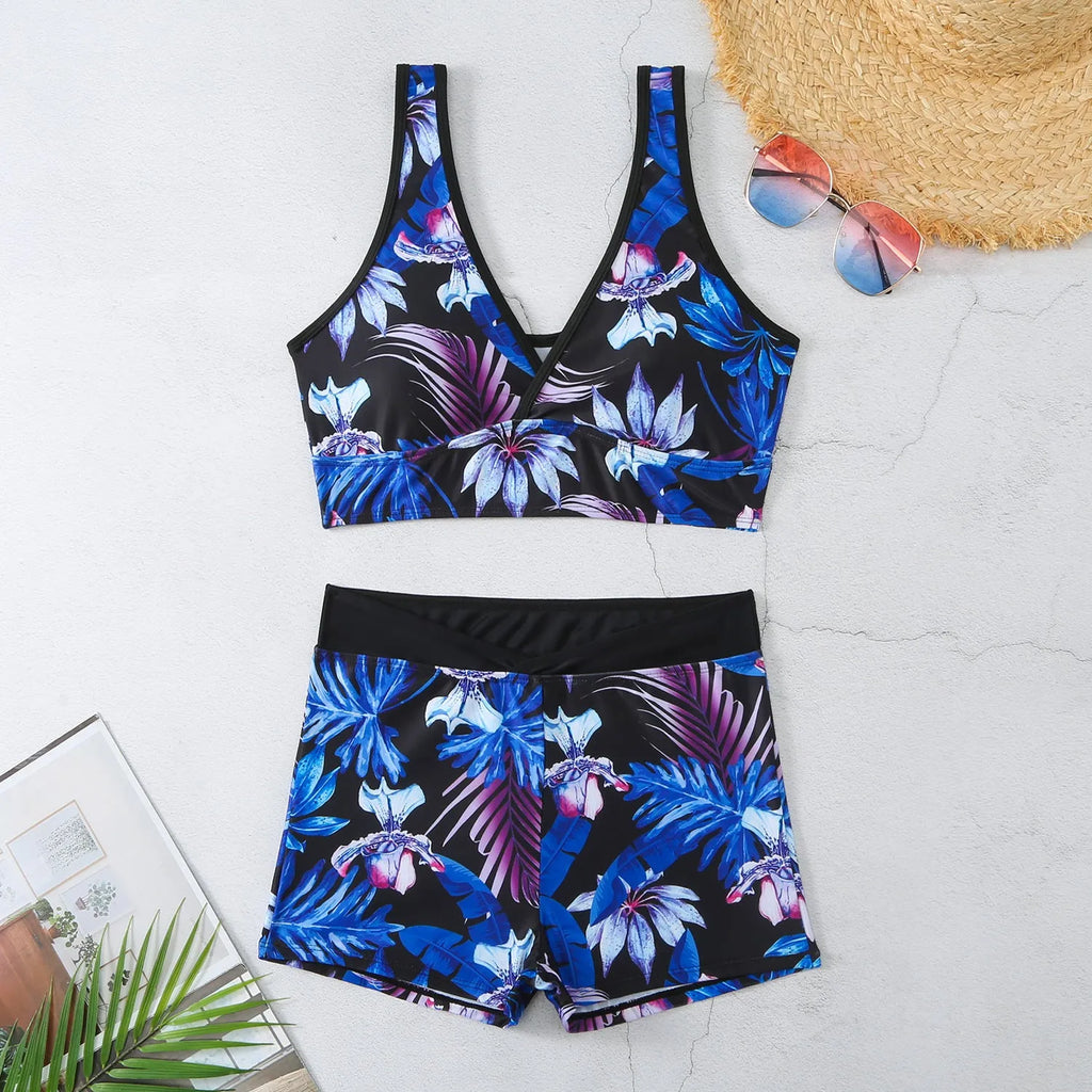 Women's two-piece swimsuit set with sleeveless top and printed boxer-style bottoms in a multi-colour pattern.