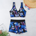 Women's two-piece swimsuit set with sleeveless top and printed boxer-style bottoms in a multi-colour pattern.