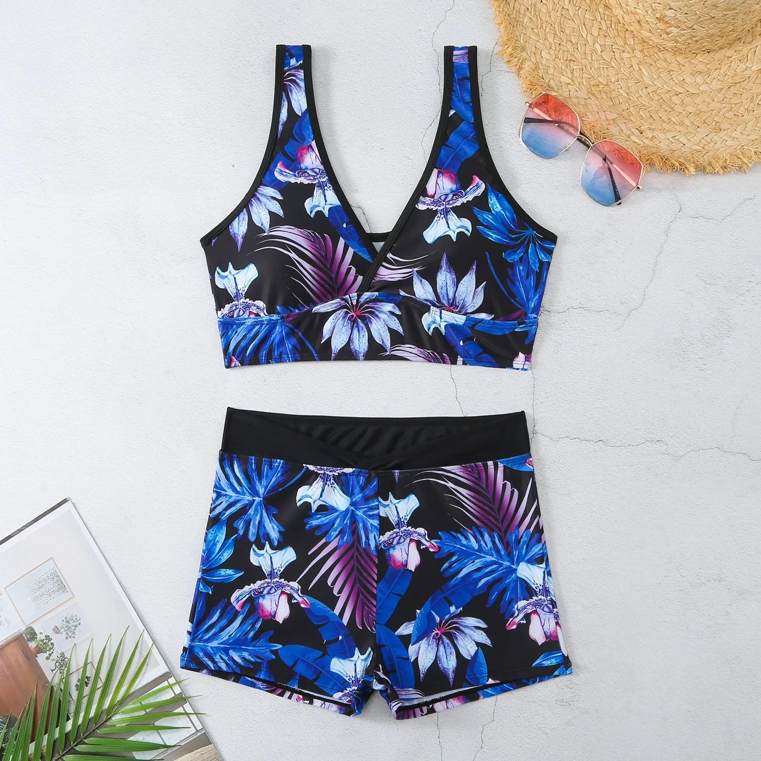Women's two-piece swimsuit set with sleeveless top and printed boxer-style bottoms in a multi-colour pattern.