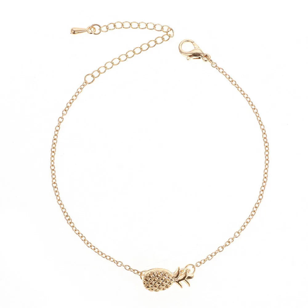 Women's alloy pineapple bracelet on wrist, showing B178 gold or silver finish and fruit-shaped design.