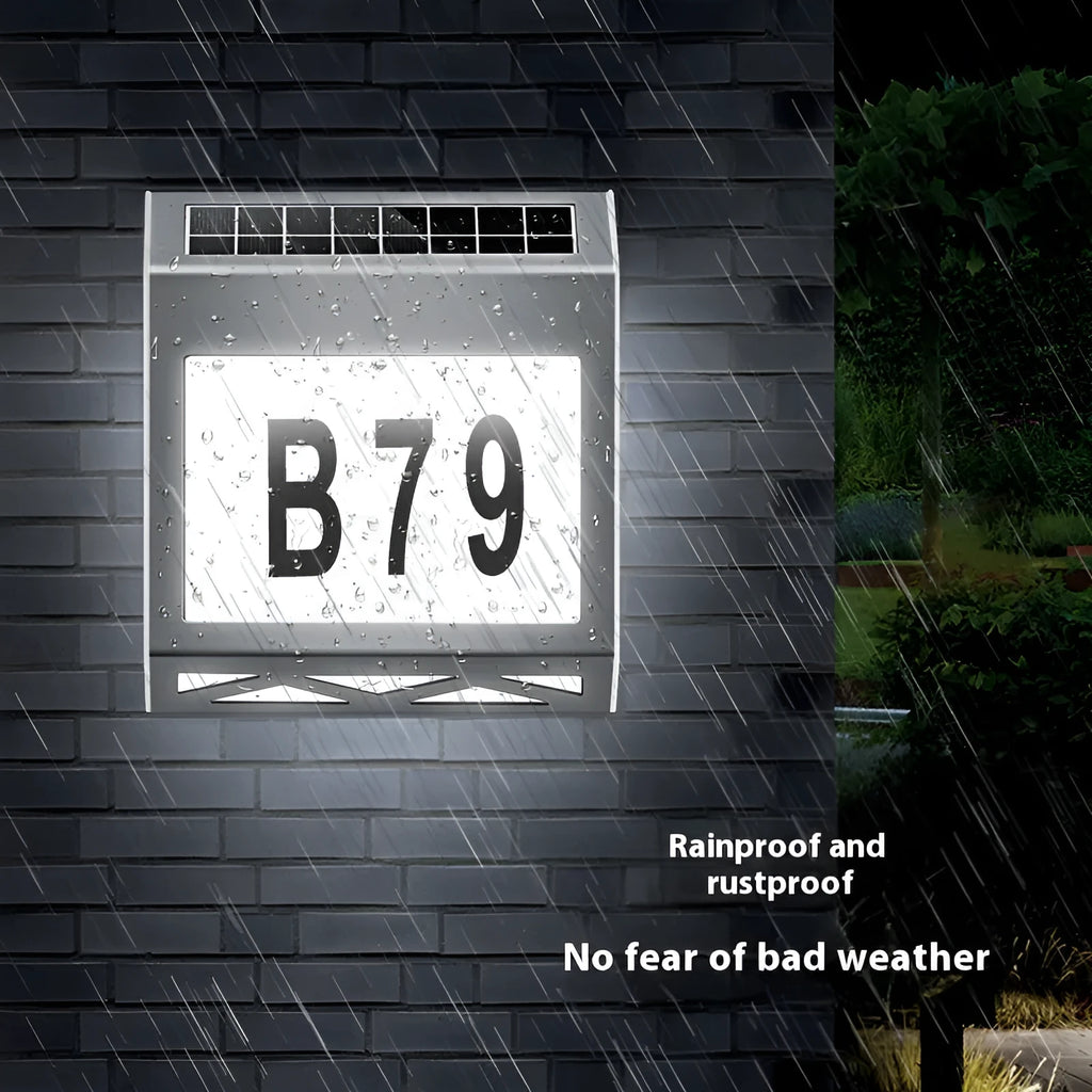 Black solar-powered doorplate light with LED illumination for house numbers measuring 180x50x200mm