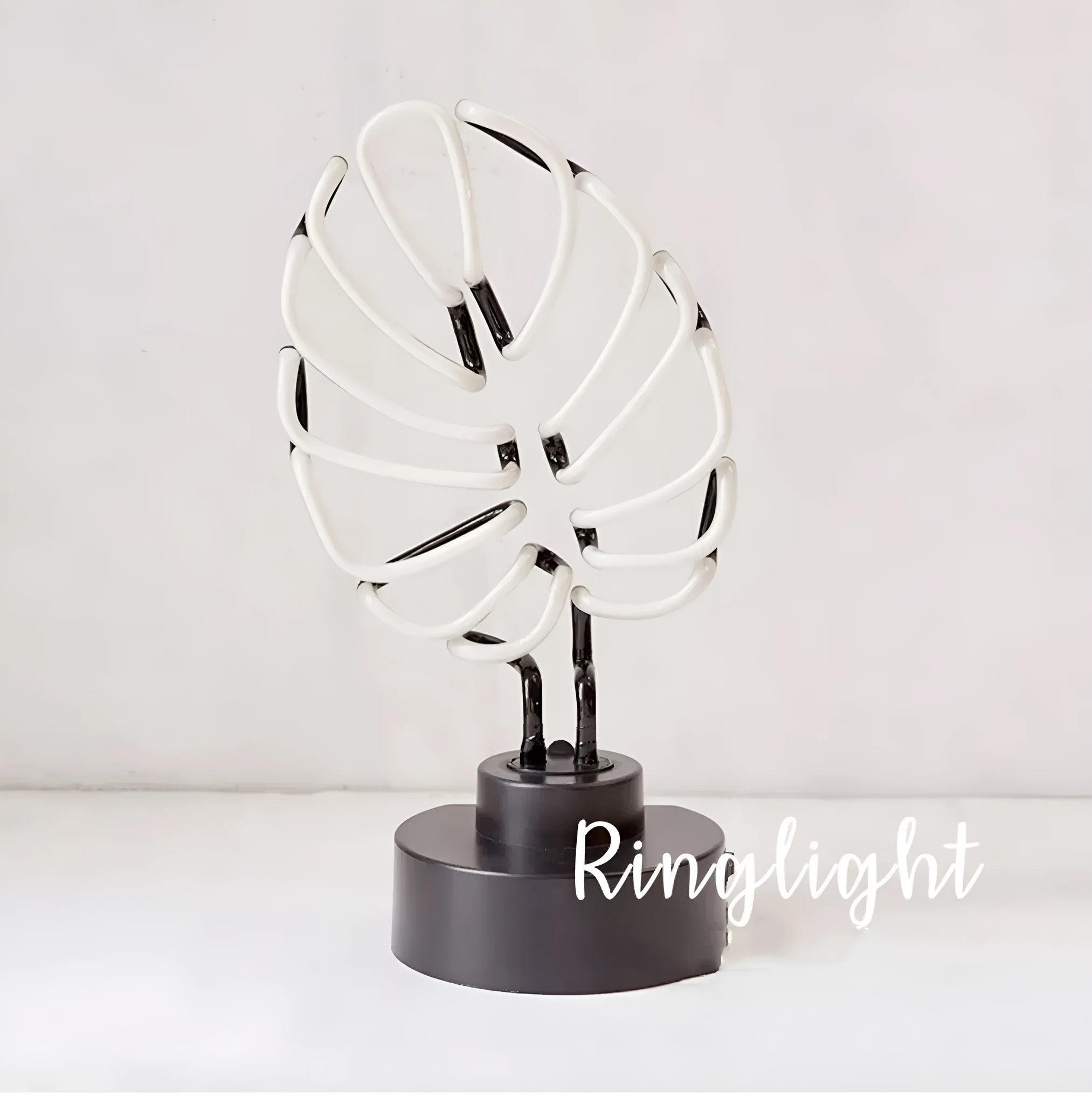 Creative minimalist bamboo-shaped desk lamp with green light on a white background.