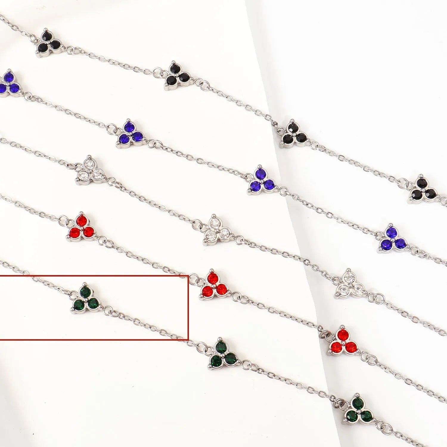 Stainless steel women's bracelet with three triangular diamond motifs set with colourful zircon stones.