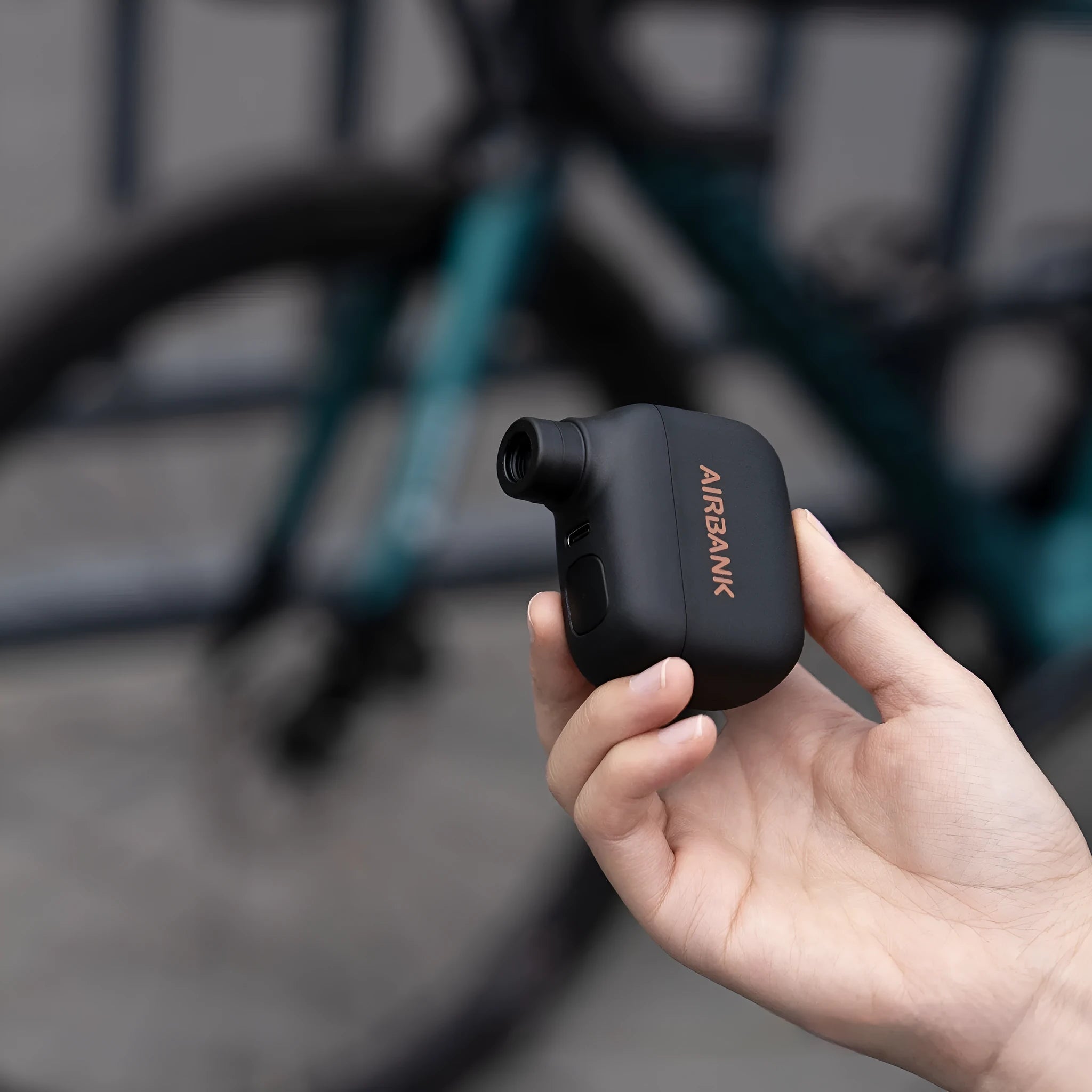 Black AS100 mini electric bike pump with USB cable and waterproof storage bag