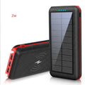 Black wireless solar power bank with Qi charging pad, three USB ports and an LED flashlight
