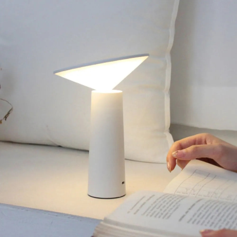 Black or white USB LED desk lamp with touch sensor and adjustable lamp head on a desk