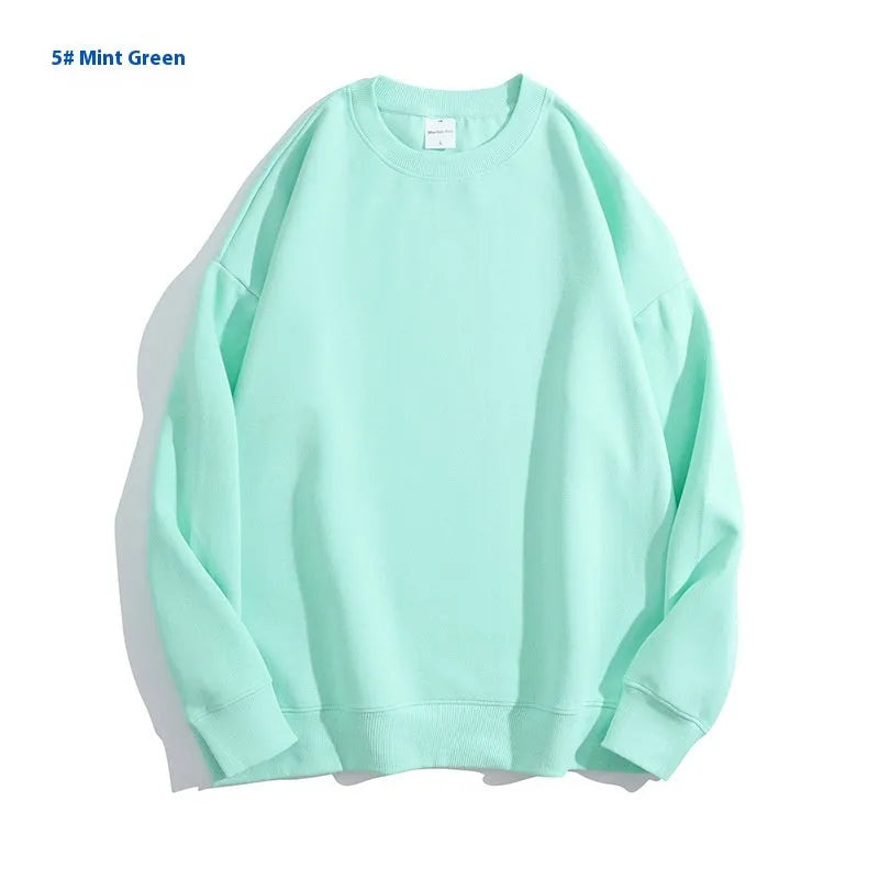 A loose-fitting, off shoulder, round neck cotton sweater in a solid colour with long sleeves.