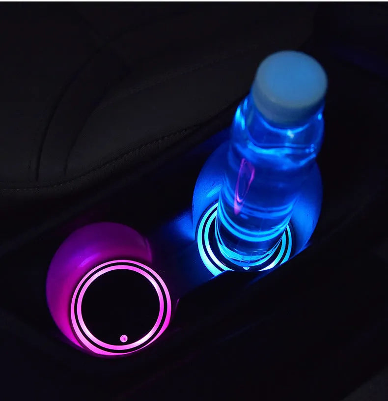 Colourful LED light-up car coaster with solar panel and USB cable on a car seat