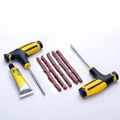 Vacuum tyre repair tool kit with probe, pin, glue and rubber strips in a black plastic case.