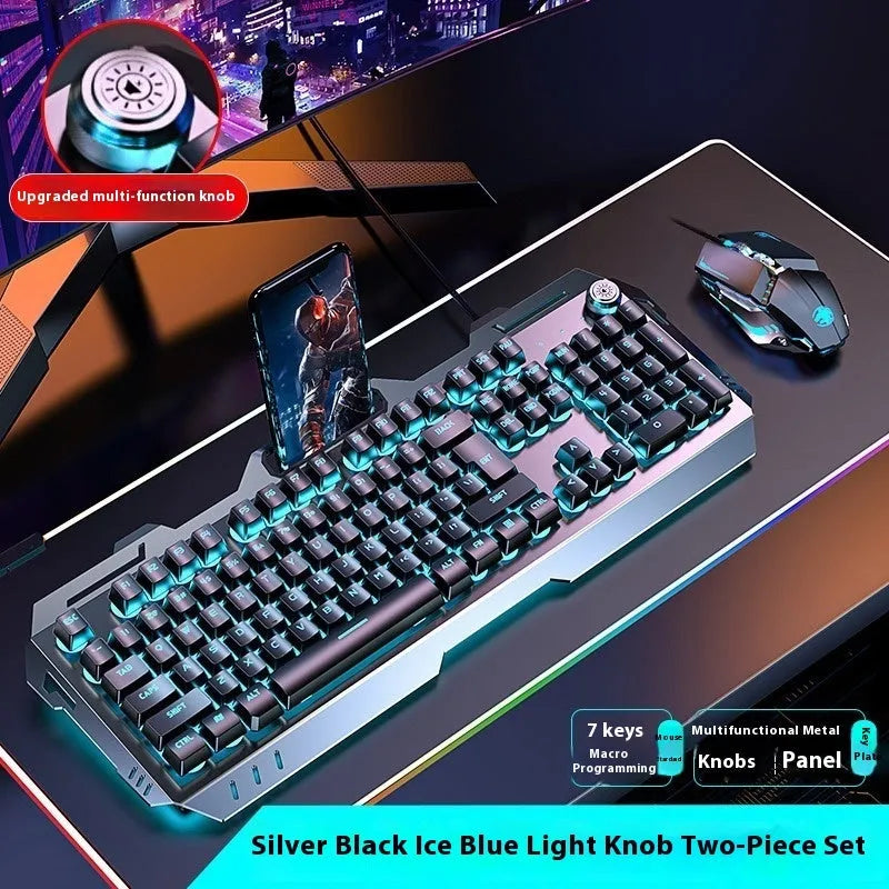 Aluminium gaming keyboard with volume knob, shown in metal grey with RGB lighting alongside optional macro mouse and headset.
