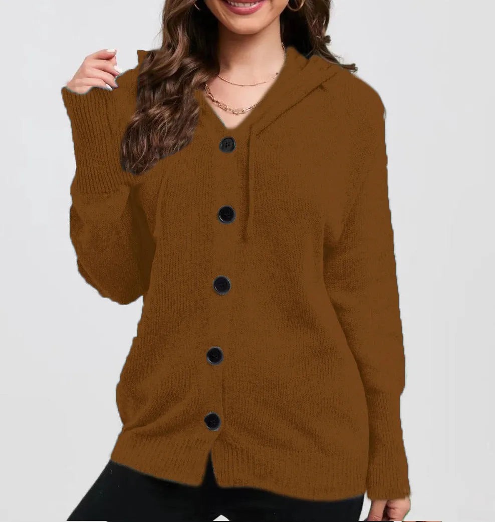 Woman wearing a thick army green zip-up hooded cardigan sweater with a loose fit.
