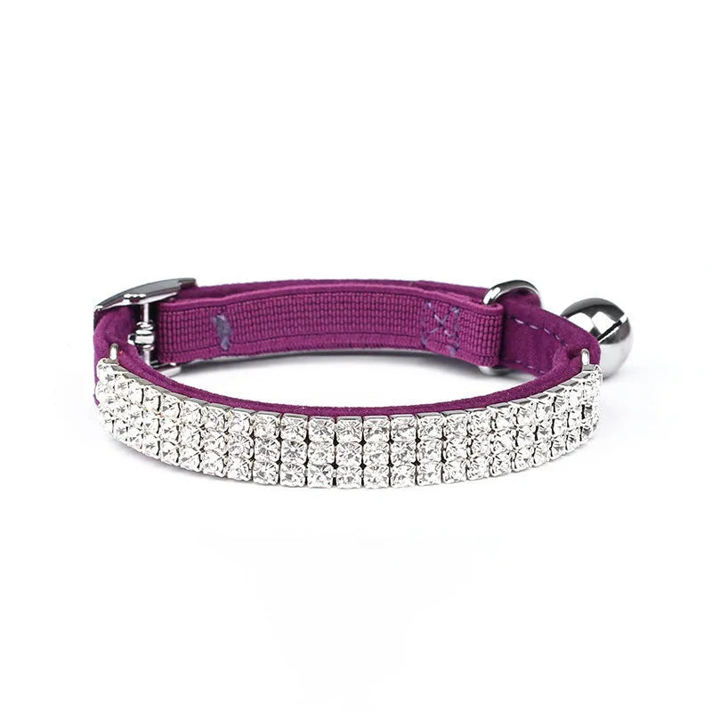 Adjustable velvet cat collar with rhinestones on a black background showing red, blue, and purple colour options.