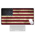 Large natural rubber desk mouse pad with a printed geometric pattern, showing non-slip base.
