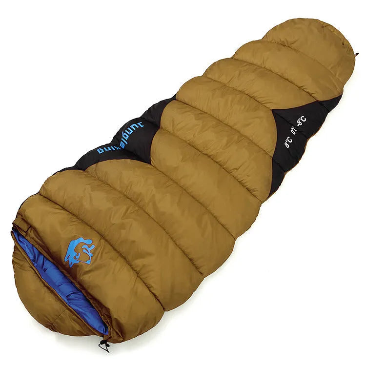 Outdoor cotton sleeping bag in Army Green with its compression storage sack laid beside it.